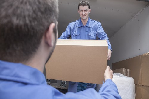 Man with van loading furniture for a removal job in Barnes