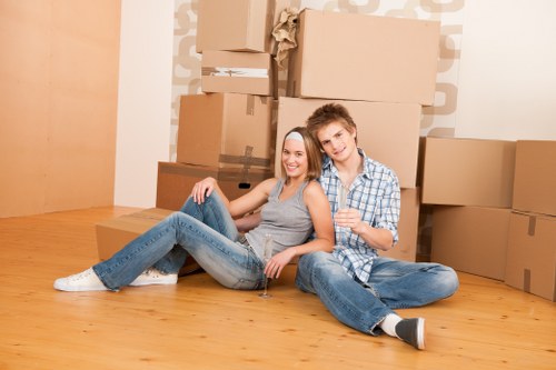 Local movers handling furniture carefully in a Barnes property
