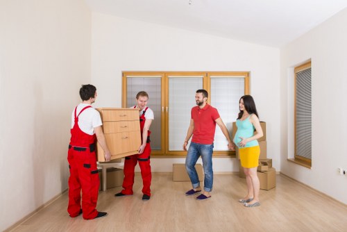 Moving van loading furniture outside a residential property