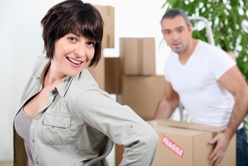 Mover carrying a wrapped item during a residential relocation